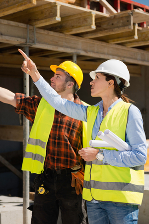 Architect and construction worker, together at construction siteの写真素材