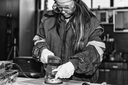 Female manual worker using power toolの写真素材