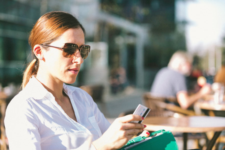 Urban woman paying with credit cardの写真素材