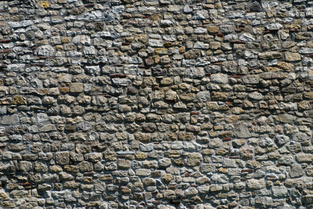 Ancient stone wall texture in flat focusの写真素材