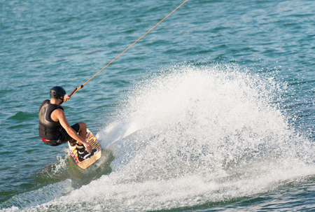 Young sportsman wakeboarding on lakeの写真素材