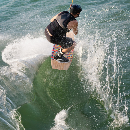 Wakeboarder creates a huge splash after jumpの写真素材