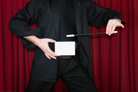 Magician presents blank invitation card on stageの写真素材