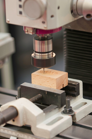 Drill press carving block of woodの写真素材