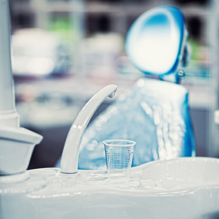 Detail from modern dental clinic. Disposable cup in focusの写真素材