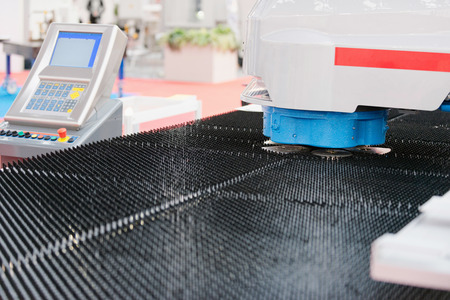 Automated metal punching and cutting machine with control panelの写真素材