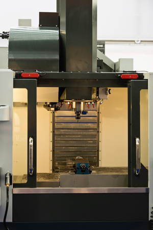 Automated metal processing lathe used in manufacturing of metal objectsの写真素材