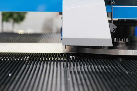 Industrial tin punching machine in modern factoryの写真素材