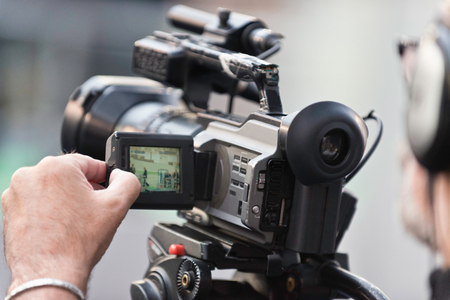 Cameraman working, camera in focusの写真素材