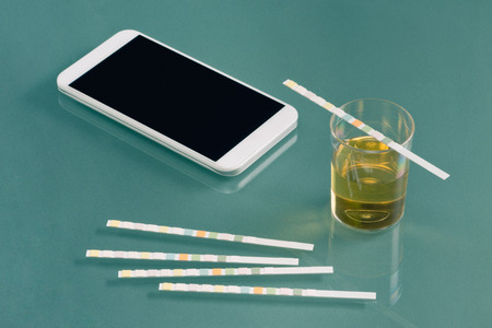 Urine testing kit with smart phoneの写真素材