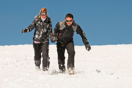 Couple walk through snowの写真素材