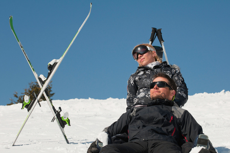 Young couple sunbathing on the snowの写真素材