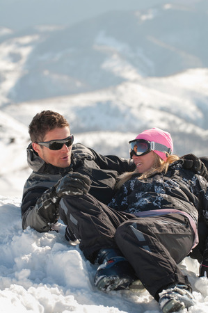 Young couple lying in the snowの写真素材