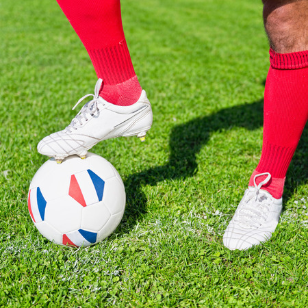 Soccer player ready to kick-off ball with French flagsの写真素材