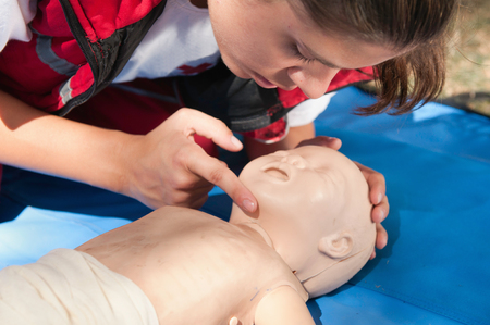 CPR trainee with an infant dummyの写真素材