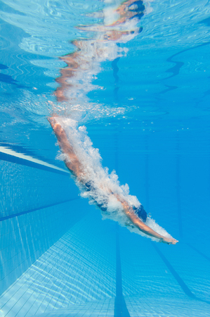 Jumping into the swimming poolの写真素材