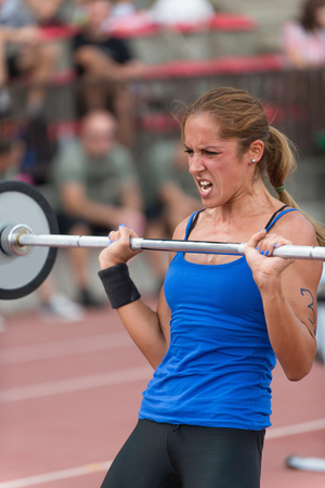 Female athlete doing deadlifts on crossfit competitionの写真素材