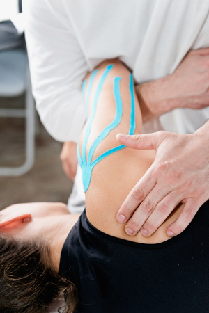 Physical therapy - therapist doing treatment on shoulderの写真素材