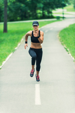 Young female athlete running outdoorsの写真素材