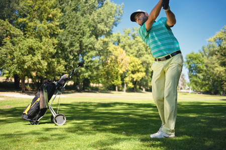Golfer preparing to play from fairwayの写真素材