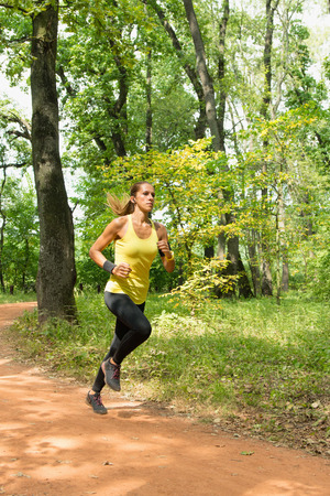 Young woman jogging in parkの写真素材