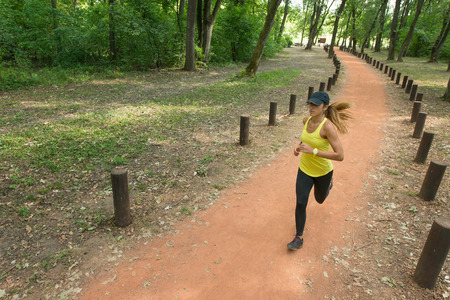 Young woman jogging in parkの写真素材