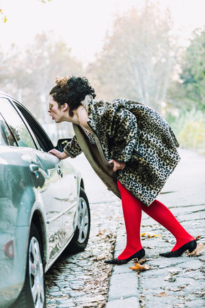 Street prostitute approaching carの写真素材