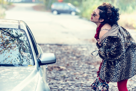 Street prostitute seducing customer in stopped carの写真素材