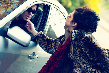 Roadside prostitute teasing car driverの写真素材