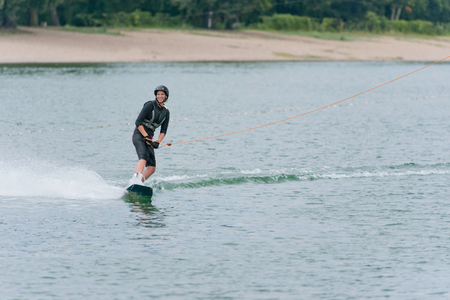 Young woman wakeboarding on lakeの写真素材