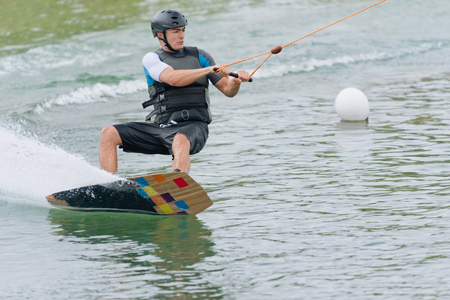 Young man riding wakeboard at high speedの写真素材