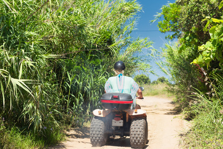 Quadbike ride through lush tropical countrysideの写真素材