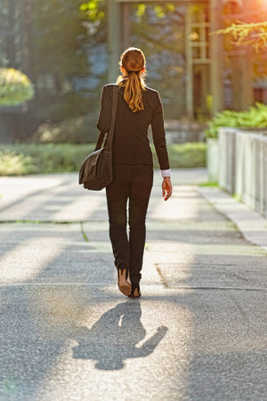 Rear view of businesswoman going to workの写真素材