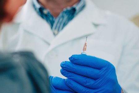 Little boy receives a vaccination in the doctors office.の写真素材