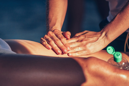 Sport therapist massaging leg of an athlete