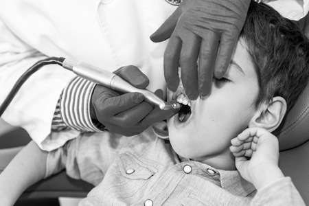 Dentist Removing Dental Calculus to Little Boyの写真素材