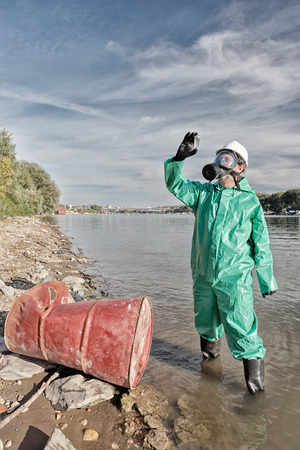 Environmentalist examining collected sample of polluted waterの写真素材