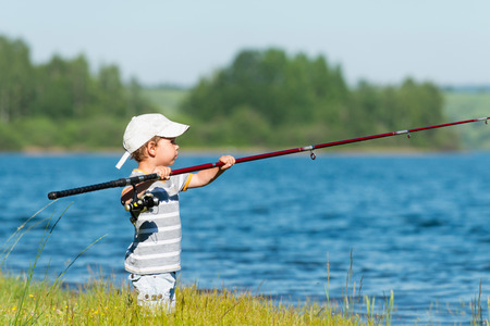 Cute little boy goes fishingの写真素材