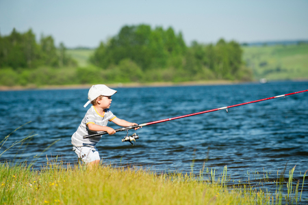 Little boy fishing on a lakeの写真素材