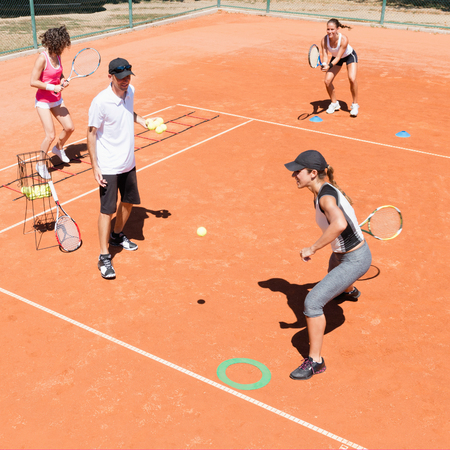 Cardio tennis class, instructor working with group of peopleの写真素材