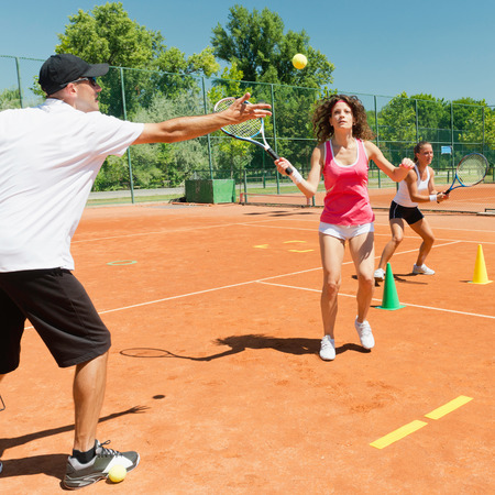 Young woman on cardio tennis workoutの写真素材