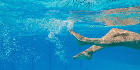 Underwater shot of splashing womens legsの写真素材