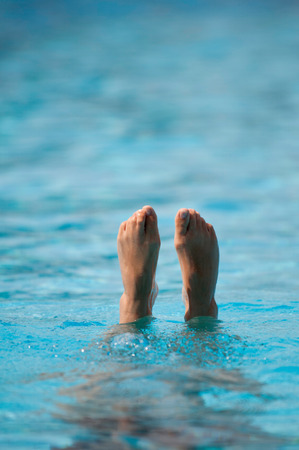 Feet of a synchronized swimmer coming out of the water. Selective focusの写真素材