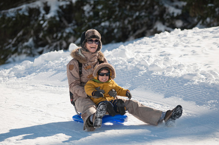 Mother and son sleddingの写真素材