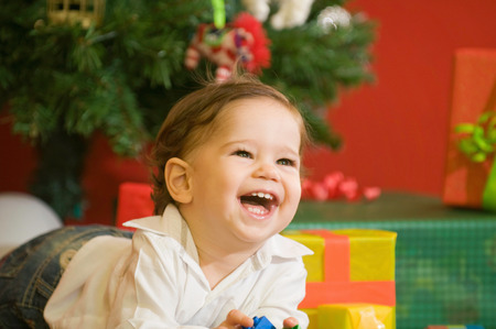 Cute baby boy excited with his Chistmas presents. Selective focusの写真素材