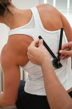 Physiotherapist measure back flexion with goniometerの写真素材