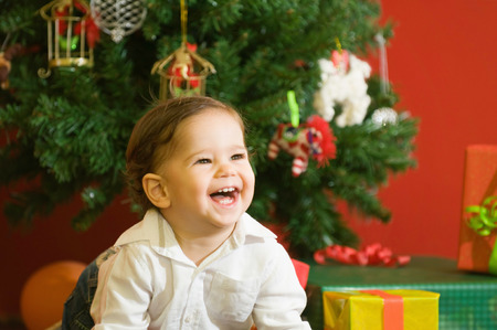 One year old baby boy surrounded with Christmas presents. Selective focusの写真素材