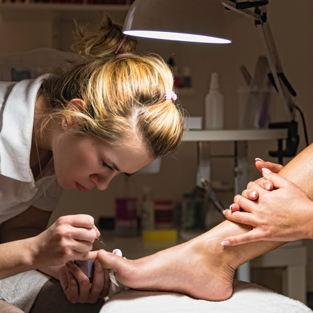 Polishing toenails in nail salonの写真素材