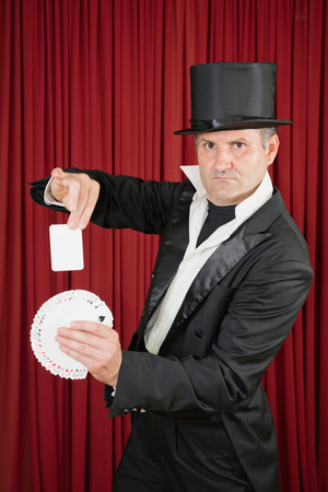 Magician doing simple trick with playing cardsの写真素材