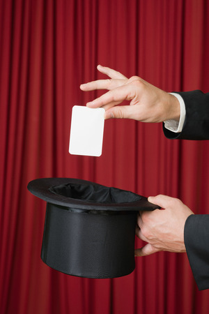Magic trick with white card and top hatの写真素材